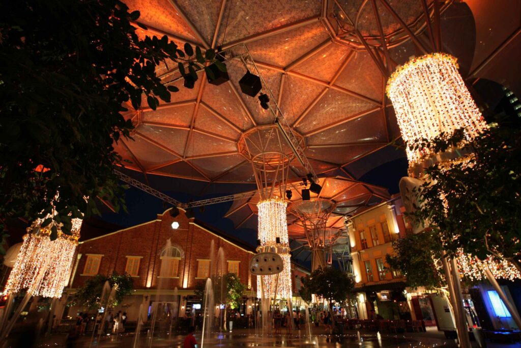 Atmospheric outdoor bar with warm string lights and decorative lanterns at night Singapore