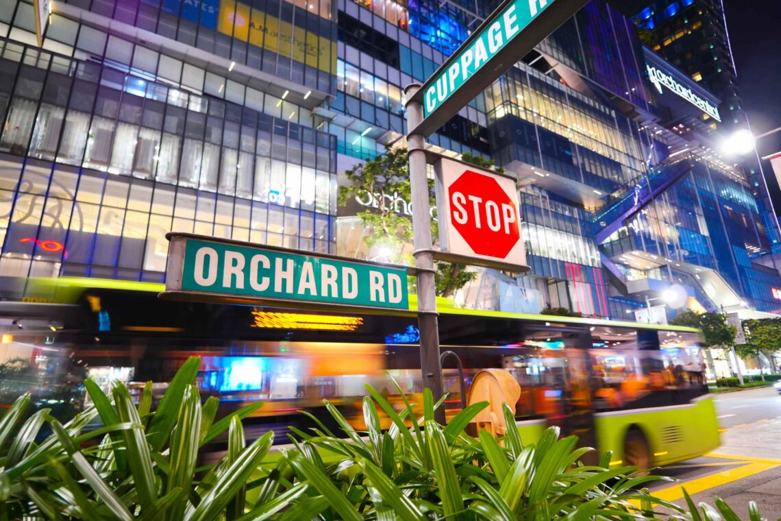 Orchard Road shopping street at night with illuminated signs and bustling crowds in Singapore - SINwebzine Orchard Road shopping street at night with illuminated signs and bustling crowds in Singapore