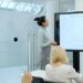 business-meeting-presentation-unsplash - SINwebzine A business reviews strategy documents at a high-rise office overlooking the Singapore headquarters district of Marina Bay