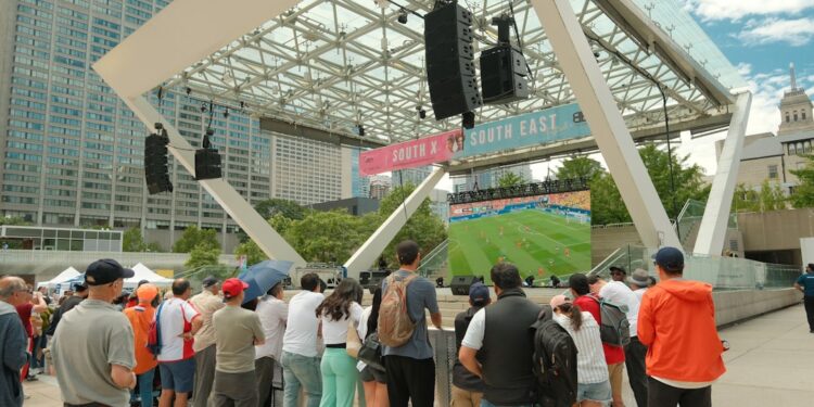 crowd-watching-sports-screen-unsplash - SINwebzine Excited fans gathered at one of Singapore's largest fan zones to watch the FIFA World Cup final weeks on a big screen