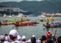 dragon-boat-racing-unsplash - SINwebzine A team of paddlers competing in June festivals Singapore dragon boat races at Bedok Reservoir, drums beating .