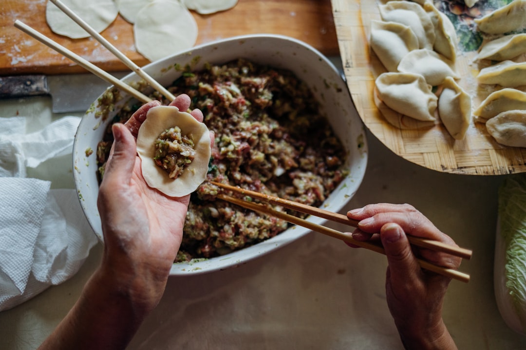 A woman demonstrating a traditional art of wrapping rice dumplings at a June festivals Singapore hawker heritage in Chinatown