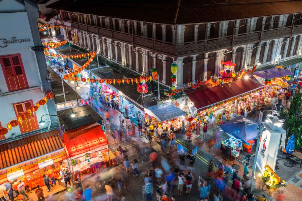 exploring Chinatown Singapore colourful shophouses street food stalls bustling atmosphere daytime