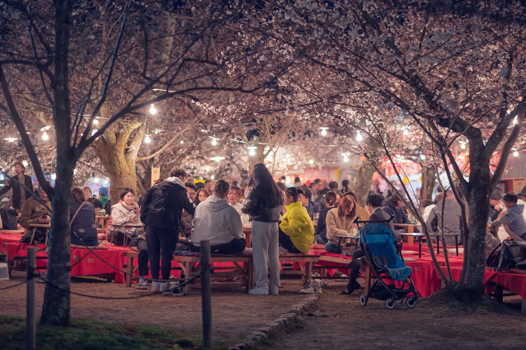Festival visitors enjoy food under evening lights at GastroBeats, where waste reduction measures are visible in the grounds