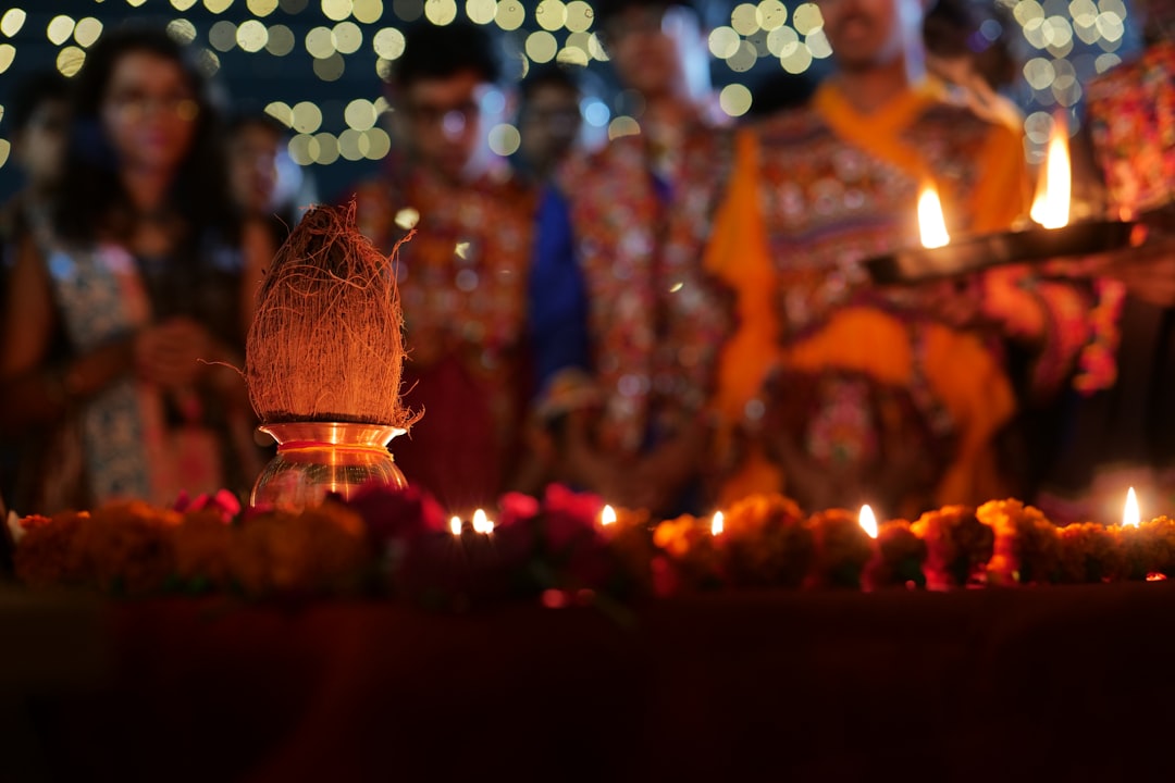 A woman lights oil lamps during Deepavali preparations in Little India, part of the Singapore rituals.
