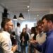 professional-networking-event-unsplash - SINwebzine A woman networking inside an elegant Singapore private members club lounge with warm lighting
