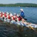 scottsboro-dragon-boat-e1752771612146 - SINwebzine A crew of paddlers competing in a dragon boat race on a calm Singapore reservoir at dawn