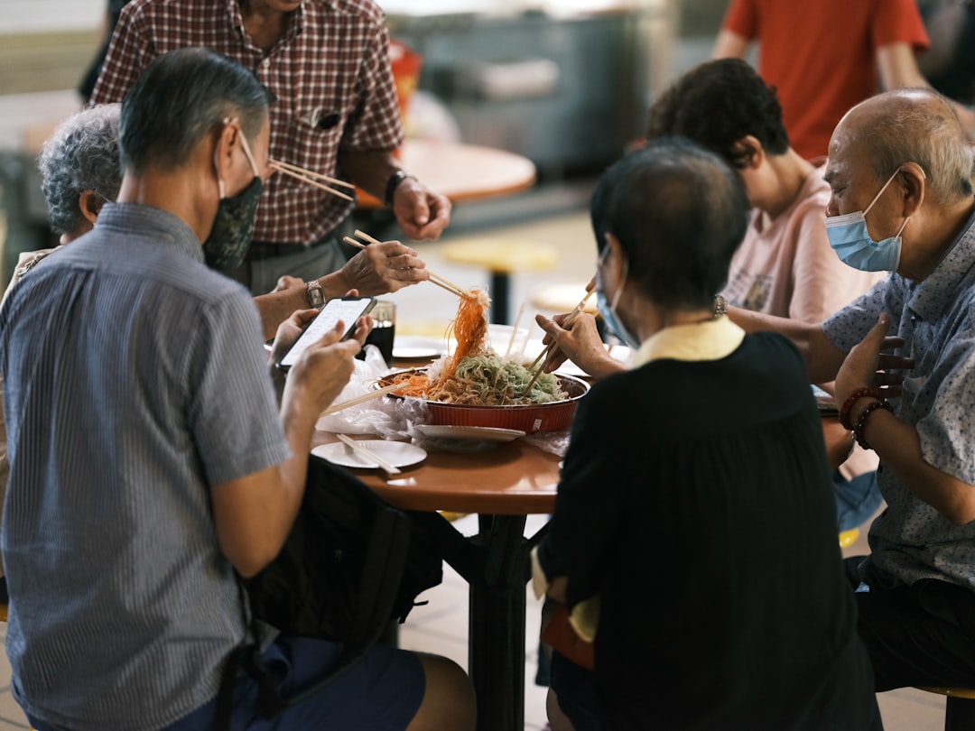 A chef presents a fusion menu dish to guests, carrying Singapore's local flavours into a global fine dining experience