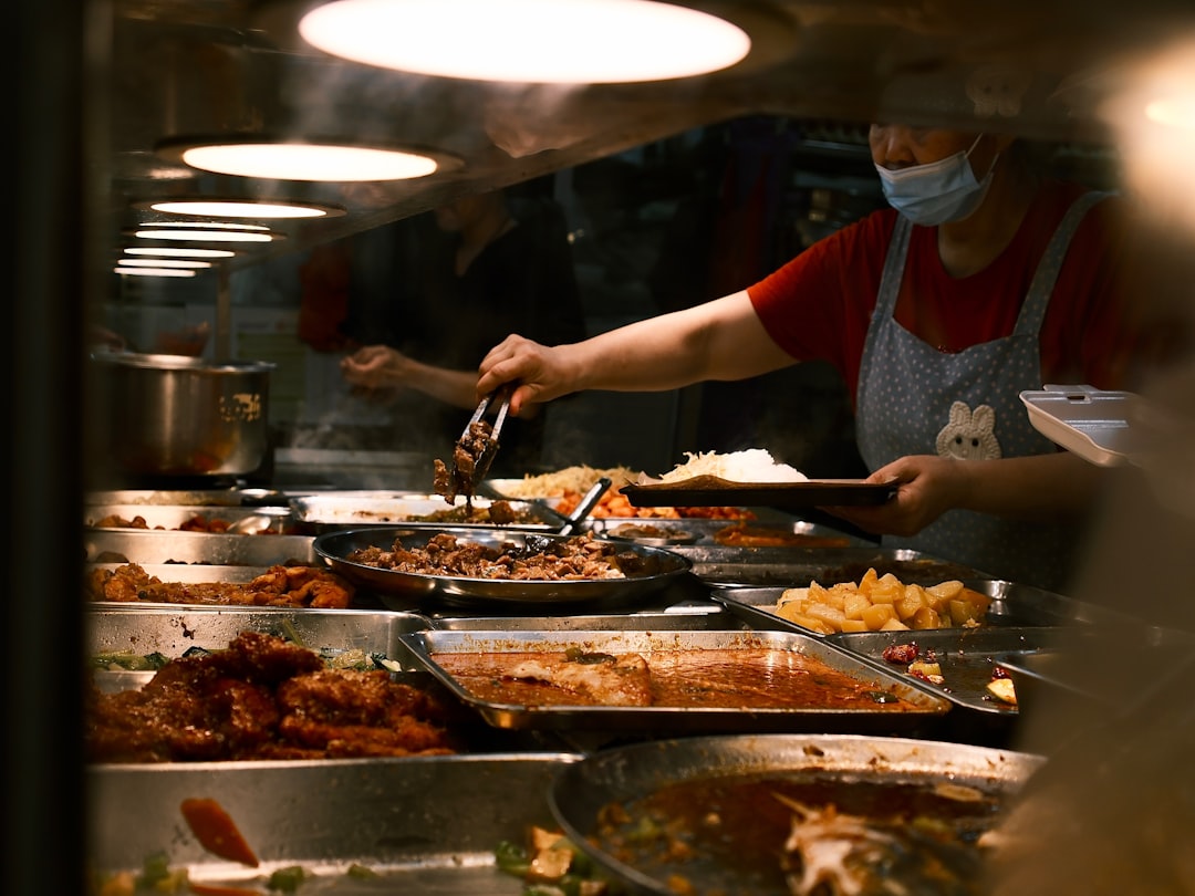 A hawker stall cook in Singapore prepares a traditional dish, showing the local flavours that inspire chefs around the world