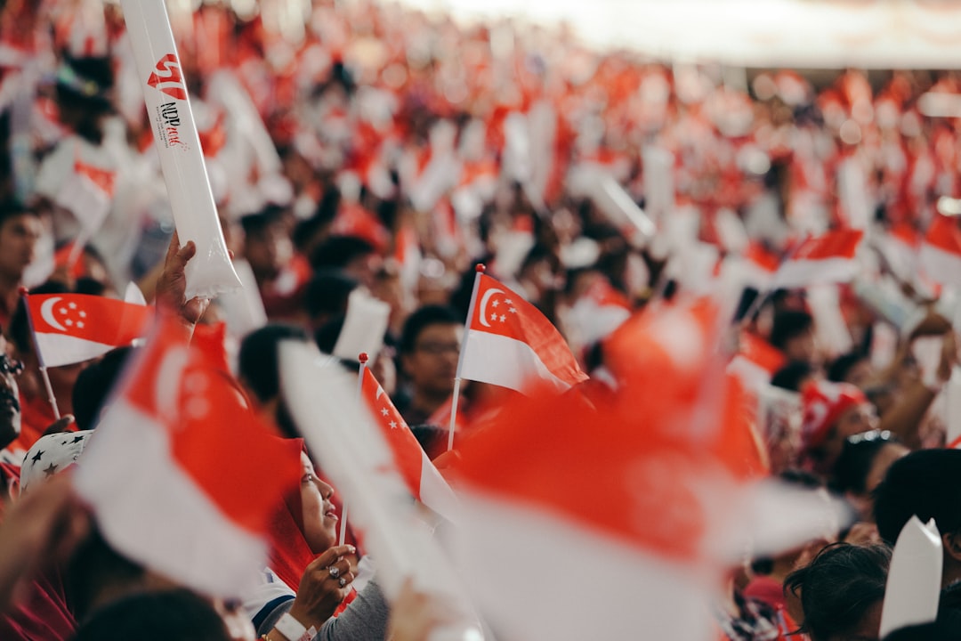 A lively sports bar crowd at a Singapore fan zones venue celebrating a goal during the FIFA World Cup final