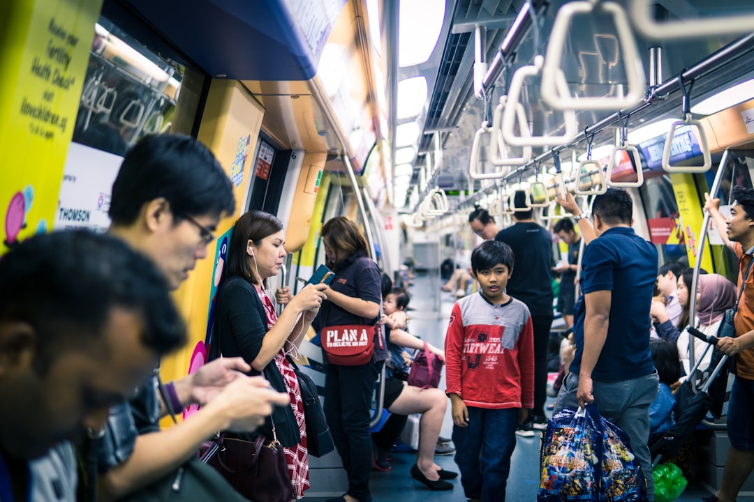A young woman on the MRT during a budget getaway across Singapore neighbourhoods