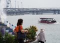 A traveller boards a ferry at Tanah Merah terminal, ready for one of the popular day trips from Singapore to Bintan Island.