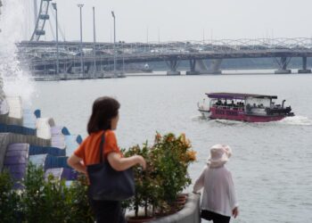 A traveller boards a ferry at Tanah Merah terminal, ready for one of the popular day trips from Singapore to Bintan Island.