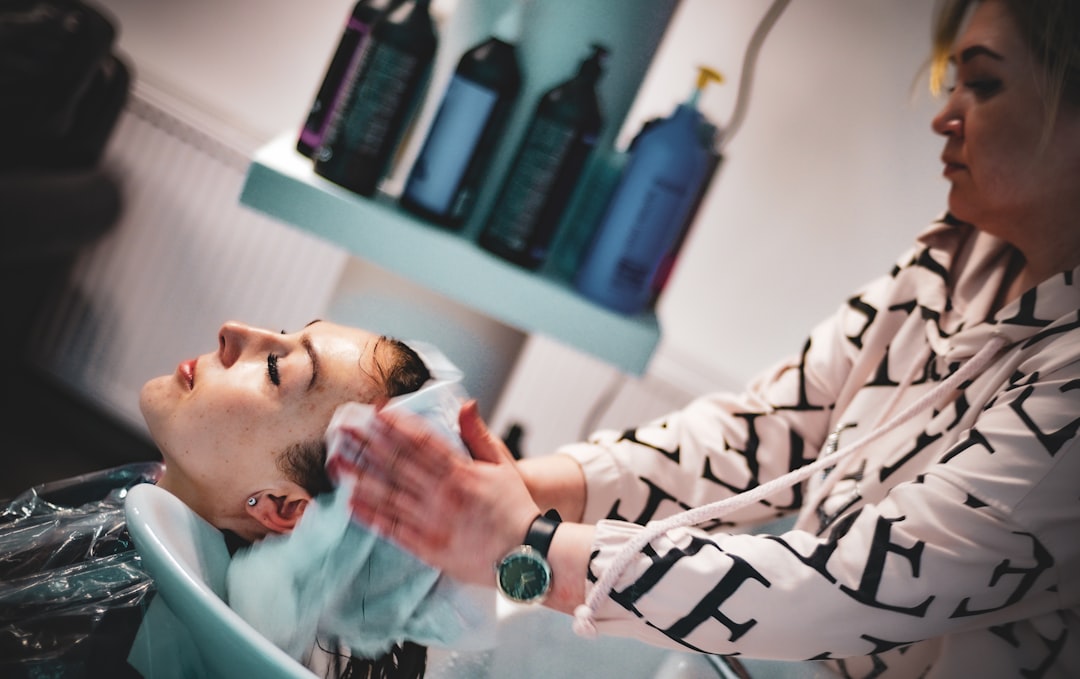 A woman applying a deep conditioning hair mask at home as part of her weekly monsoon beauty care routine