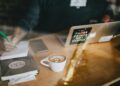 work-coffee-unsplash - SINwebzine A diaspora entrepreneur works at a centre cafe, illustrating the hustle of diaspora entrepreneurs building a businesses