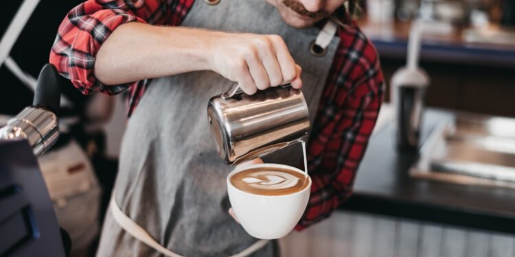 barista-pouring-latte-art-competition-unsplash - SINwebzine A skilled barista concentrates during a Singapore coffee championship latte art round