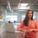 business-woman-office-unsplash - SINwebzine A financial advisor in Singapore reviews MAS policy documents with a client at her desk in a downtown office building.