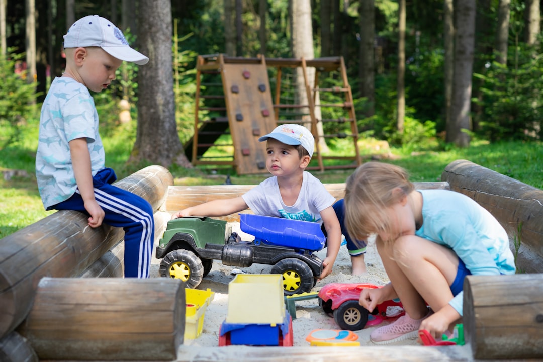 Two children performing an outdoor experiment together at a science workshop camp in Singapore