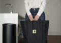 composting-kitchen-waste-unsplash - SINwebzine A woman sorting food scraps into a small bin for HDB composting in a Singapore kitchen