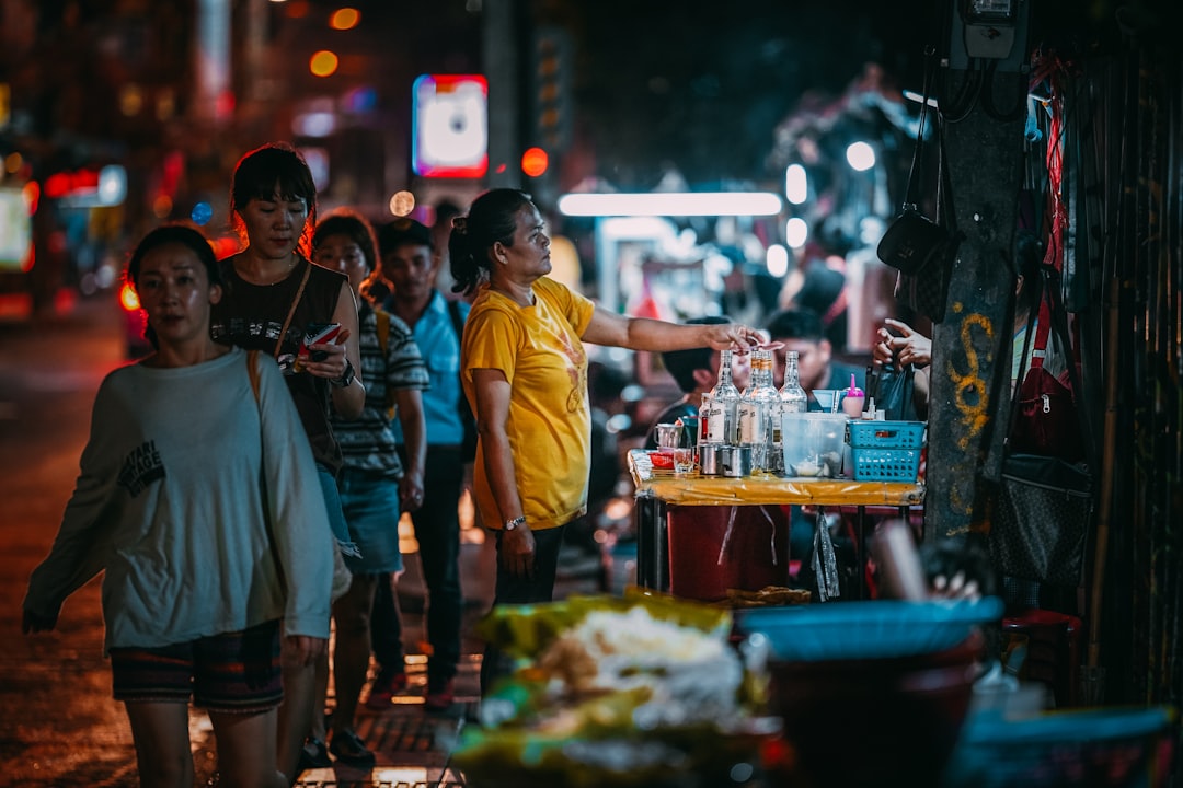 People walk through a night market in Bangkok, enjoying one of the most popular weekend escapes from Singapore