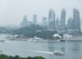 ferry-singapore-sea-unsplash - SINwebzine A traveller on a ferry heading to the southern islands of Singapore, with the city skyline in the background