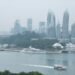 A traveller on a ferry heading to the southern islands of Singapore, with the city skyline in the background