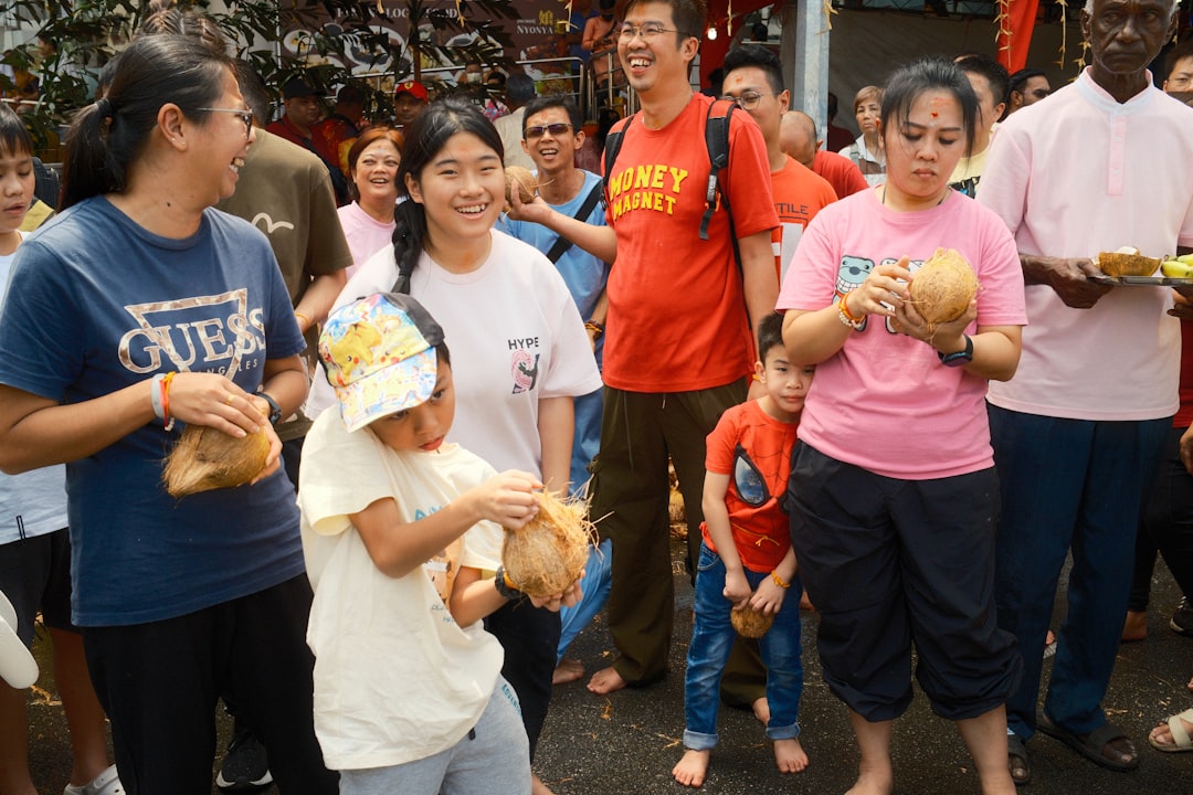 A group of friends share plates of street food at a George Town hawker stall during a weekend escape from Singapore