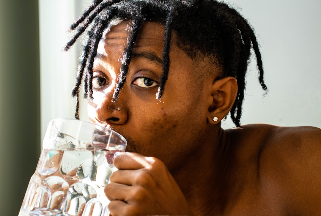 A man following a nighttime cooling routine to reduce the effects of July humidity on sleep quality