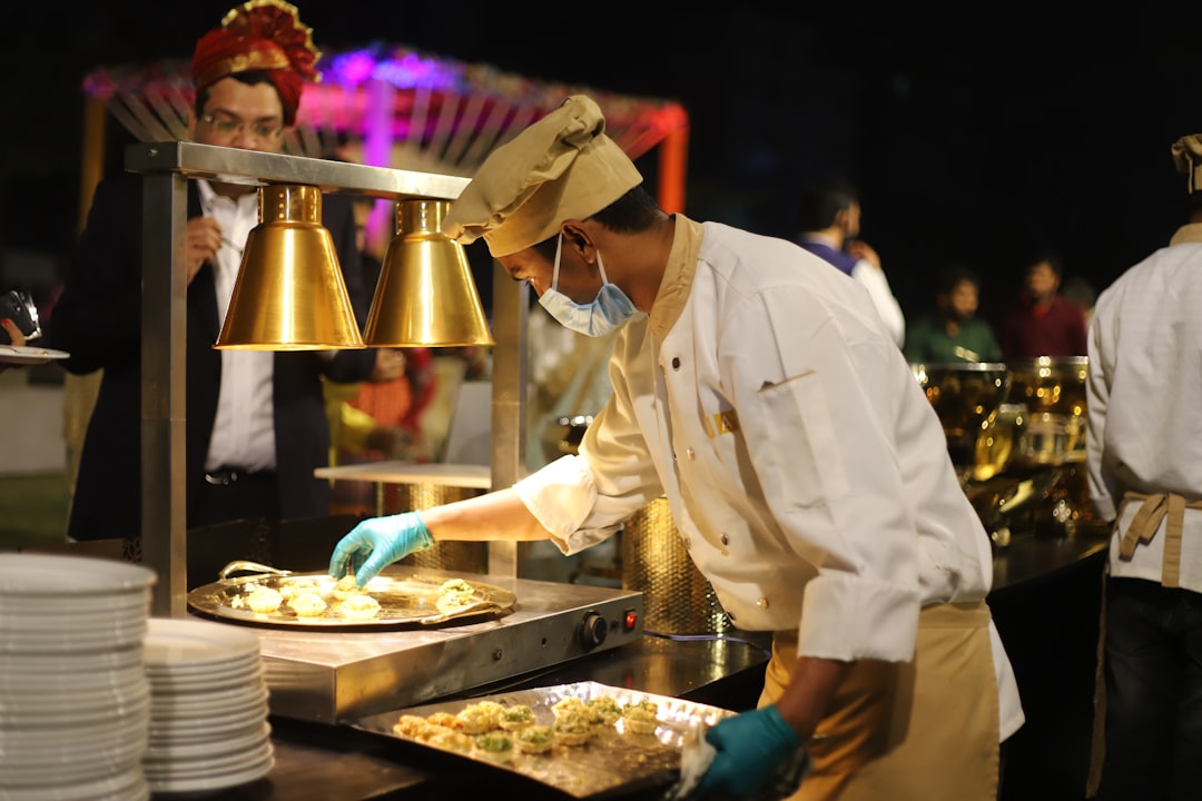 A chef plating an omakase course at a Singapore food festival beachfront dining experience