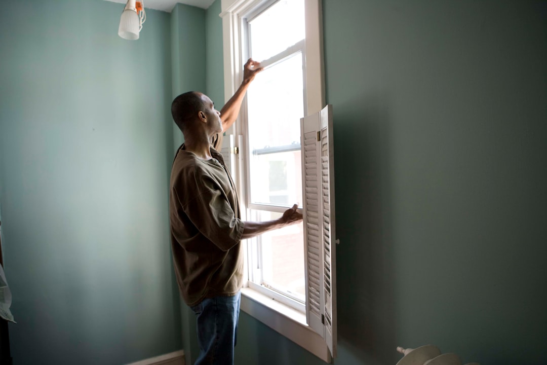 A person setting a bedroom air conditioner to manage July humidity for better sleep