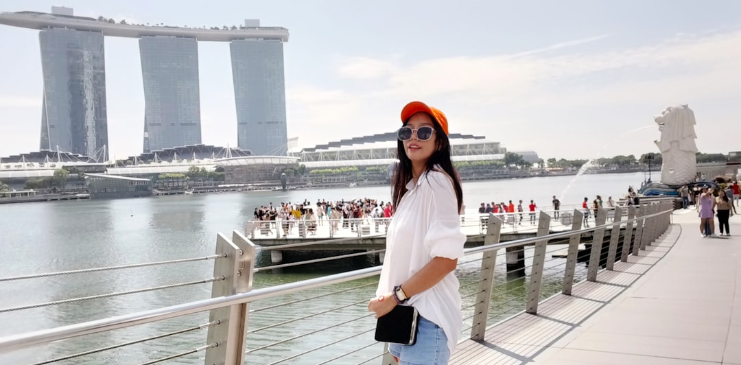 A professional woman in Singapore tracking the SGD movements tied to MAS policy decisions.