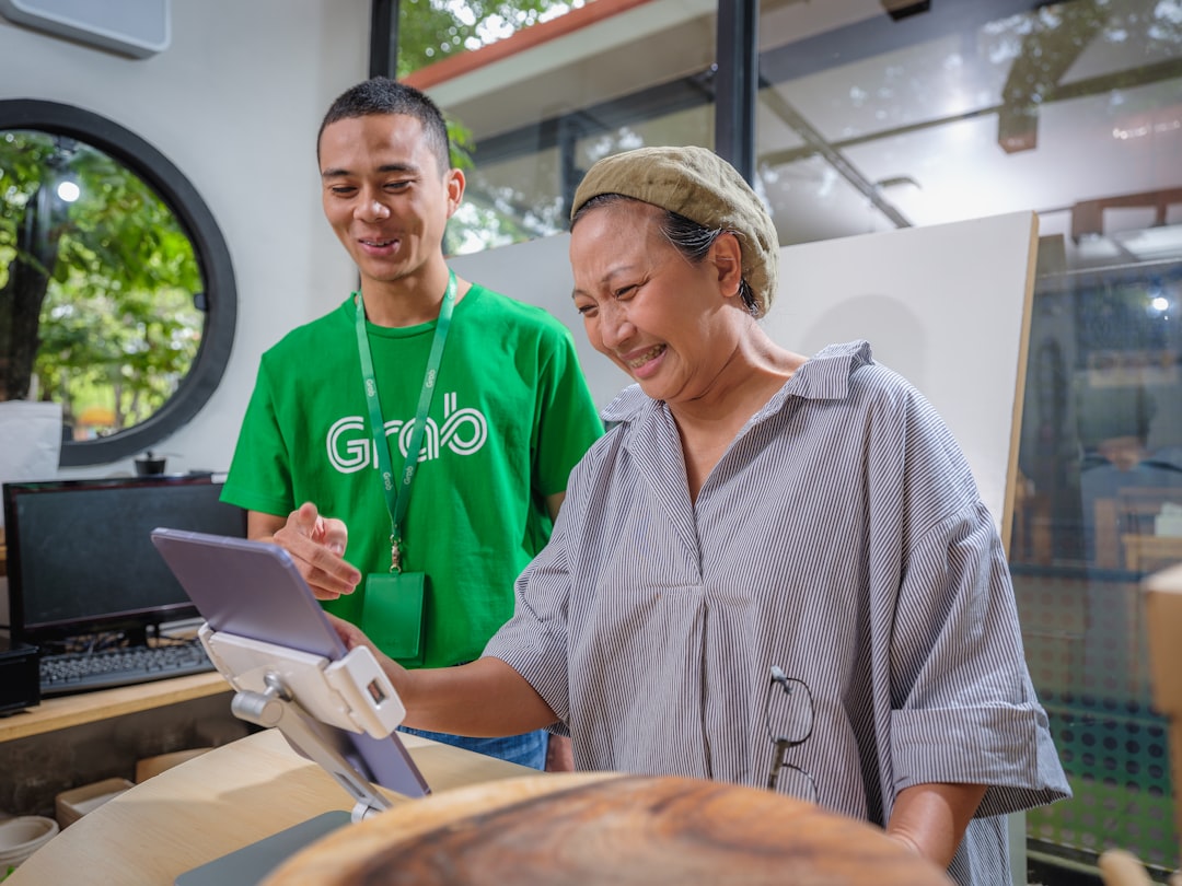 A startup founder meeting with a mentor to discuss Singapore grants and eligibility requirements