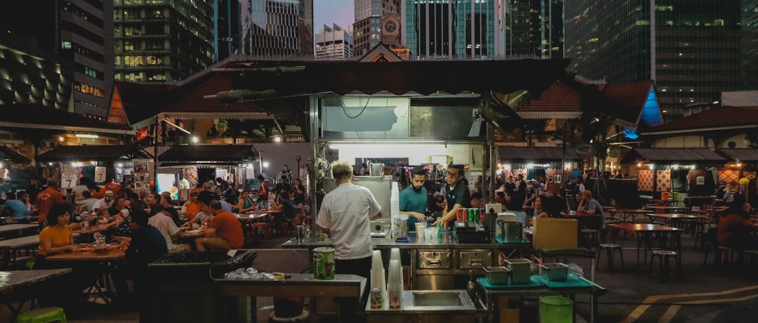 A visitor tasting heritage dishes at a Singapore food festival hawker trail event