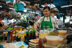 A hawker stallholder in Singapore serves Hainanese chicken rice, one of the most beloved National Day dishes on the island.