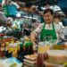 A hawker stallholder in Singapore serves Hainanese chicken rice, one of the most beloved National Day dishes on the island.