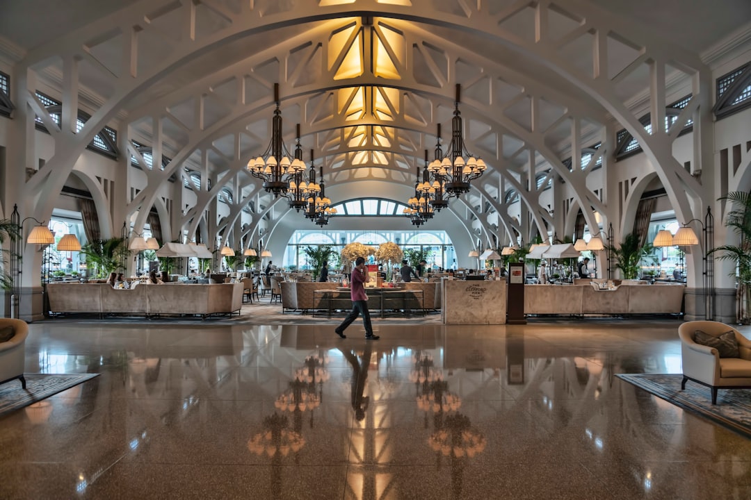 A hotel concierge assists a guest at check-in as Singapore tourist arrivals drive strong hospitality demand