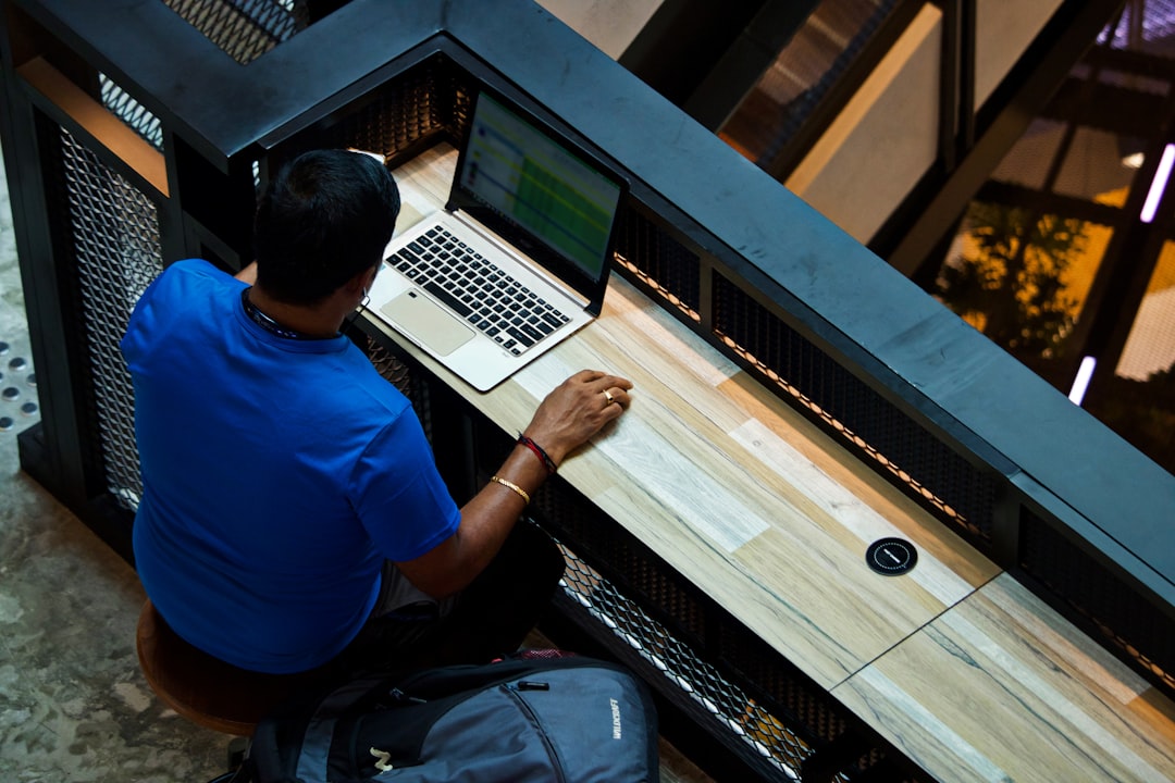A Singapore-based investor examines equity portfolio charts, reflecting on the impact of MAS policy on his investments.
