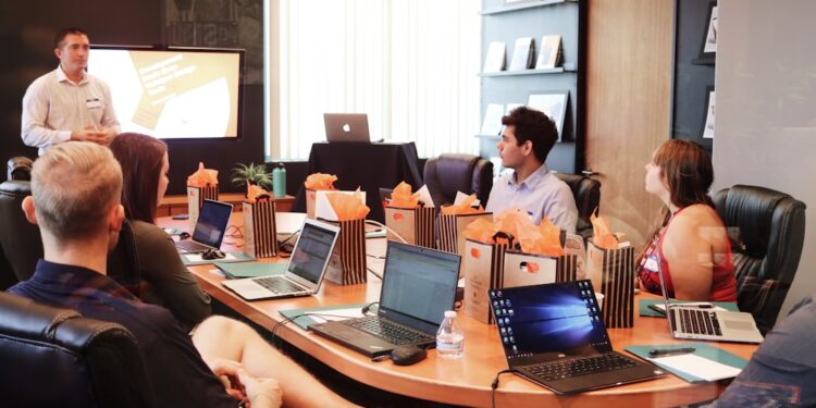 A Singapore startup founder reviews equity crowdfunding platform options on a laptop during a funding meeting