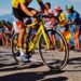 tour-de-france-unsplash - SINwebzine A cyclist racing at speed through city streets during the Singapore criterium, with spectators watching from the roadside