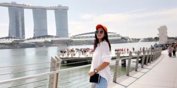 A traveller carrying a backpack boards a ferry at a Singapore terminal, ready for one of many weekend escapes from Singapore