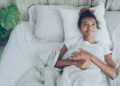 woman-lying-awake-bedroom-tropical-night-unsplash - SINwebzine A woman lying awake in a warm Singapore bedroom, struggling with July humidity and poor sleep