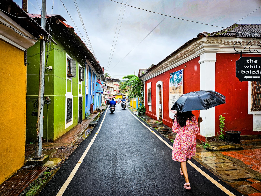 A woman placing a compact umbrella preparing her July wardrobe essentials for Singapore's wet-season commute.