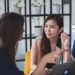 A professional woman in a Singapore office reviews documents during the city's August hiring surge