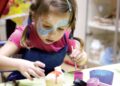children-craft-workshop-unsplash - SINwebzine A child enjoying National Day activities at an arts and craft workshop in Singapore, painting red and white designs