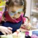children-craft-workshop-unsplash - SINwebzine A child enjoying National Day activities at an arts and craft workshop in Singapore, painting red and white designs