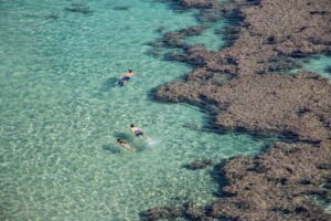 A couple snorkelling in turquoise water during one of the most popular island escapes reachable from Singapore in late August