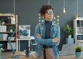foreign-entrepreneur-standing-in-office-unsplash - SINwebzine A foreign founder reviews documents at a desk while setting up a Singapore company remotely