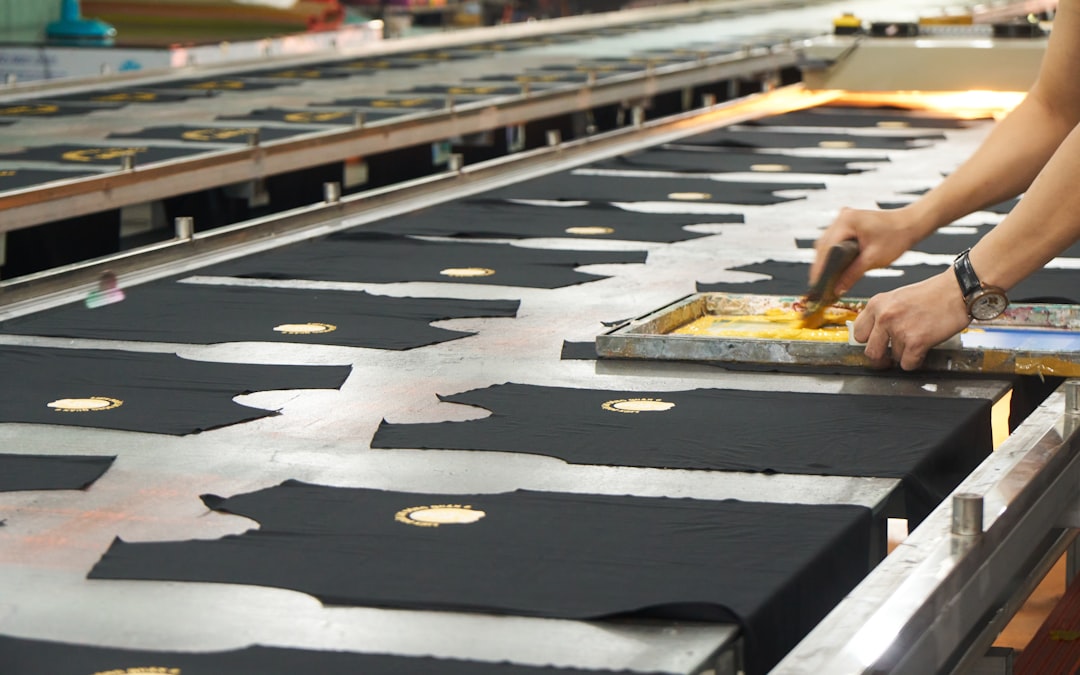 A small group of students learning screen printing techniques on fabric at a Singapore studio