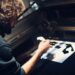 A man carefully pulls ink across a frame during a screen printing workshop in Singapore