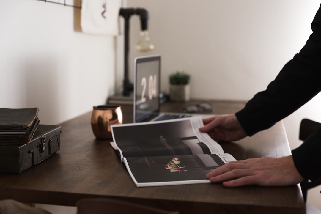 A financial professional discussing an art advisory portfolio report with a client in a Singapore office